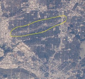An aerial view of a city with a yellow circle in the middle