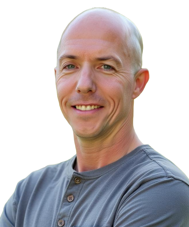 A bald person smiling at the camera, wearing a grey, button-up henley shirt against a white background.