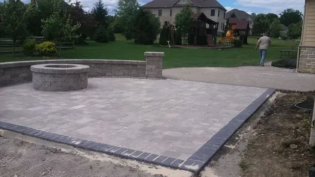 There is a fire pit in the middle of the patio.