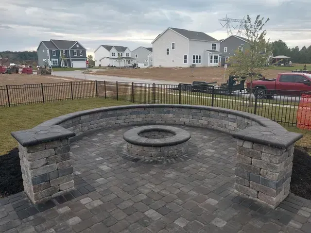 There is a fire pit in the middle of the patio.