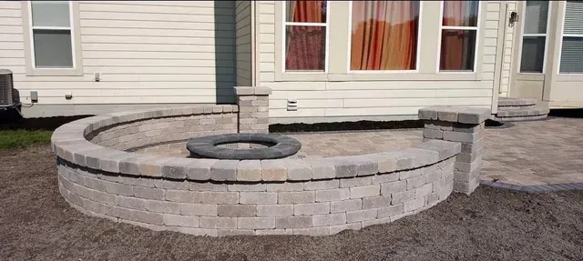 A fire pit is being built in front of a house.