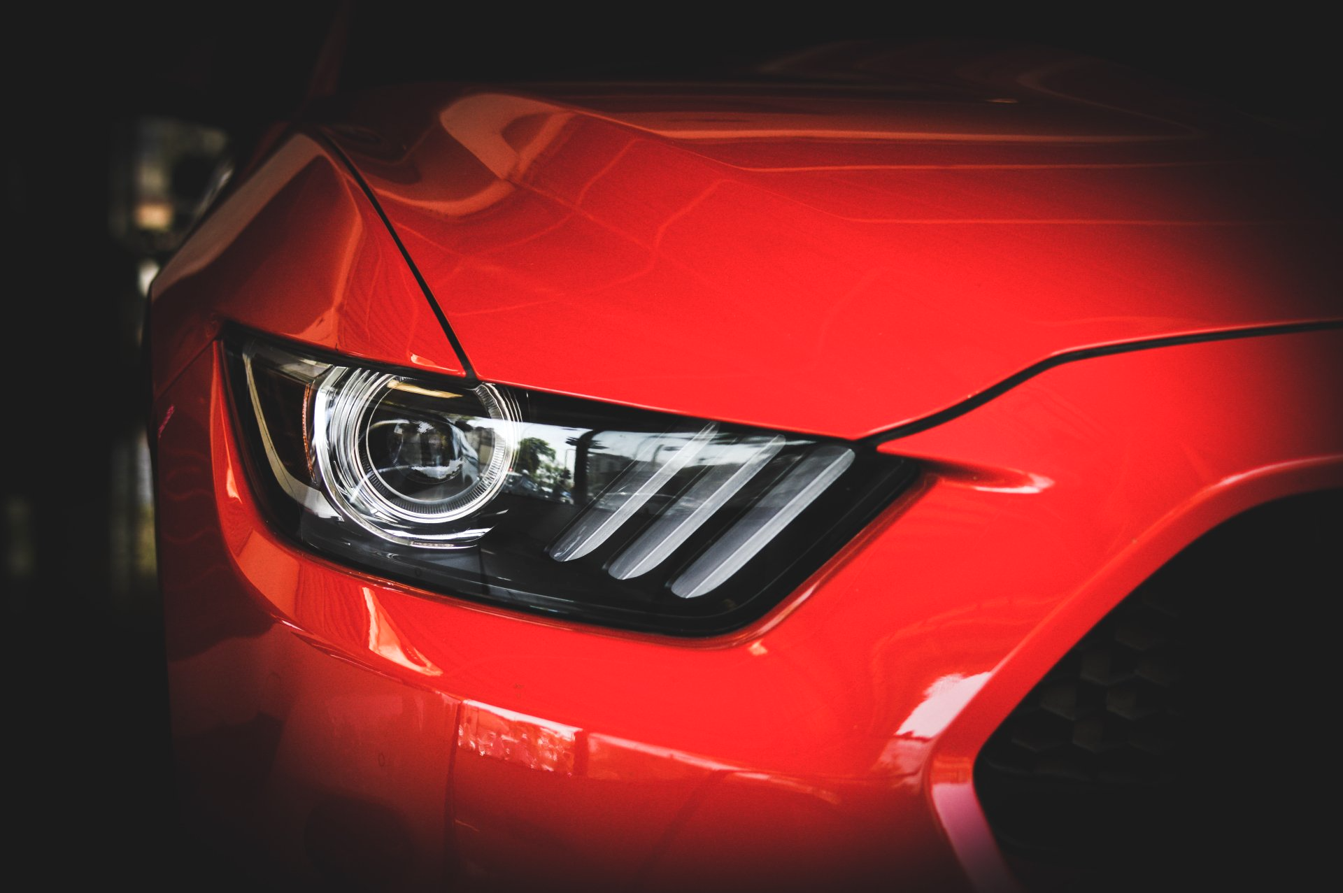 Clear Coat Protection - image of shiny red car headlight