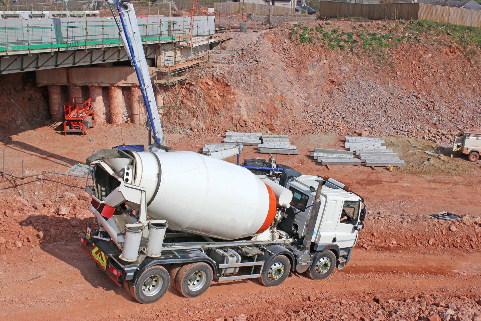 A concrete mixer truck at a construction site. 