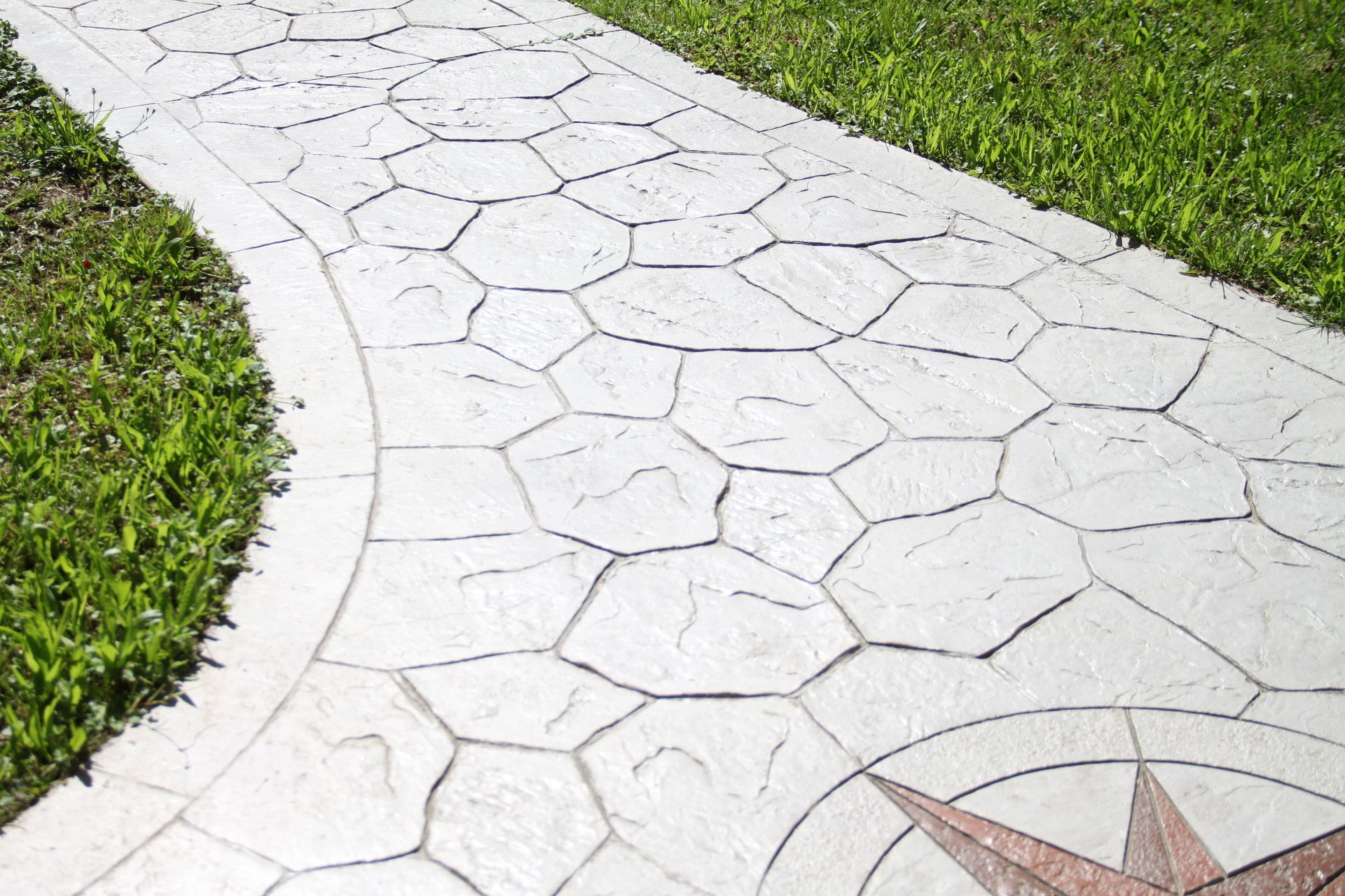 A printed grey decorative concrete path compass.
