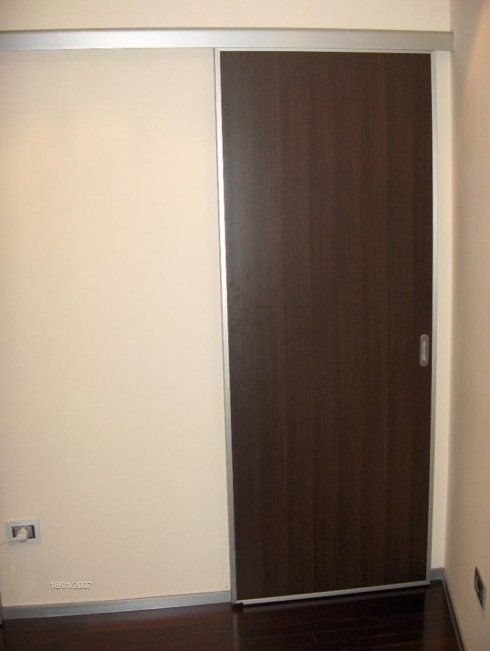 Porta scorrevole marrone scuro con finiture argentate