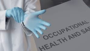 Blue-gloved hands beside a gray folder labeled “Occupational Health and Safety”