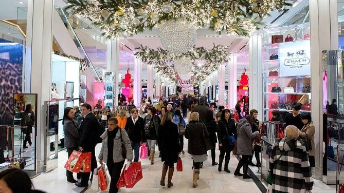 A large group of people are shopping in a mall.