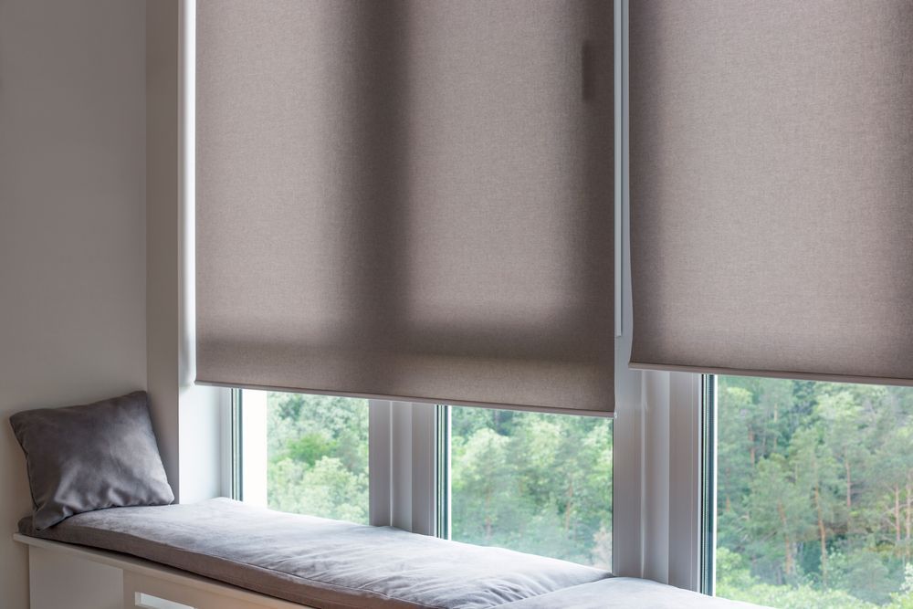 Window Seat With Grey Cushions Beside Large Windows Covered by Beige Blinds — Another Blind Man in Maroochydore, QLD