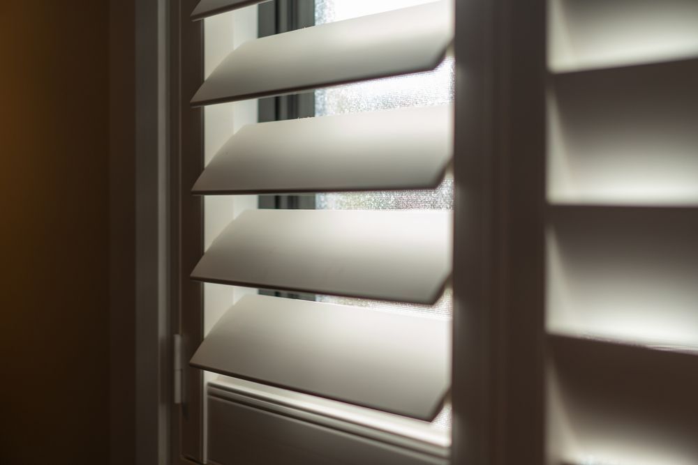 White Window Blinds With Sunlight Streaming Through, Casting Shadows on the Slats — Another Blind Man in Caloundra, QLD