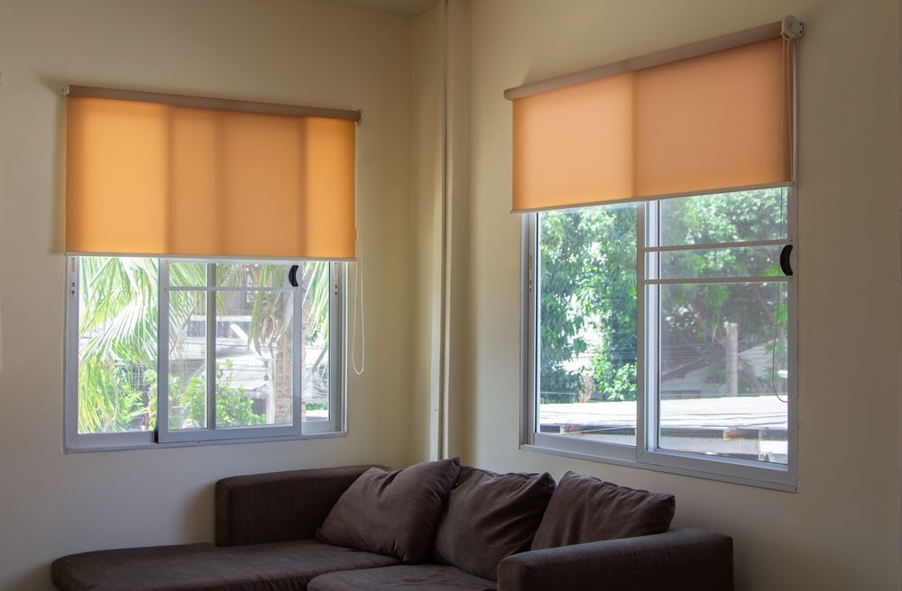 Corner Living Room With Brown Sectional Sofa and Two Windows — Another Blind Man in Maroochydore, QLD