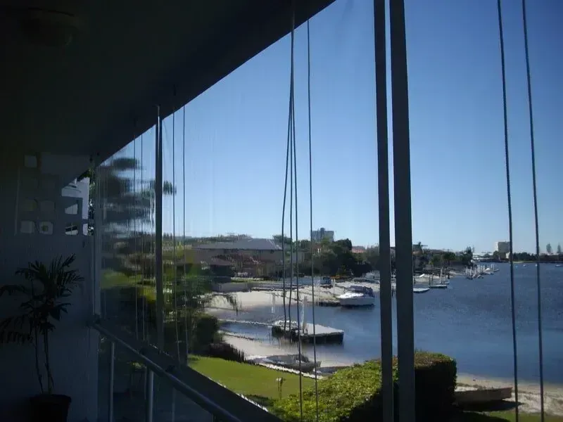 View of a Marina With Boats on Calm Water, Seen From a Shaded Balcony — Another Blind Man in Tewantin, QLD