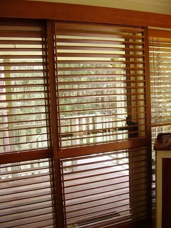 Wooden Blinds Covering Tall Windows With a View of Trees Outside — Another Blind Man in Tewantin, QLD