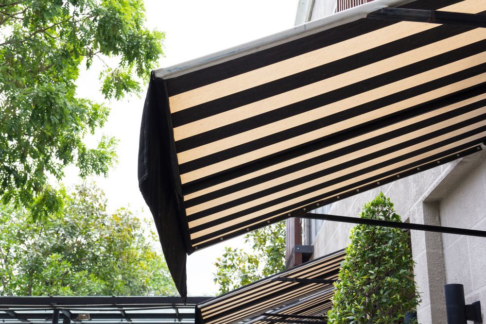 Black-and-white Striped Awning Extending Over a Building With Trees in the Background — Another Blind Man in Tewantin, QLD