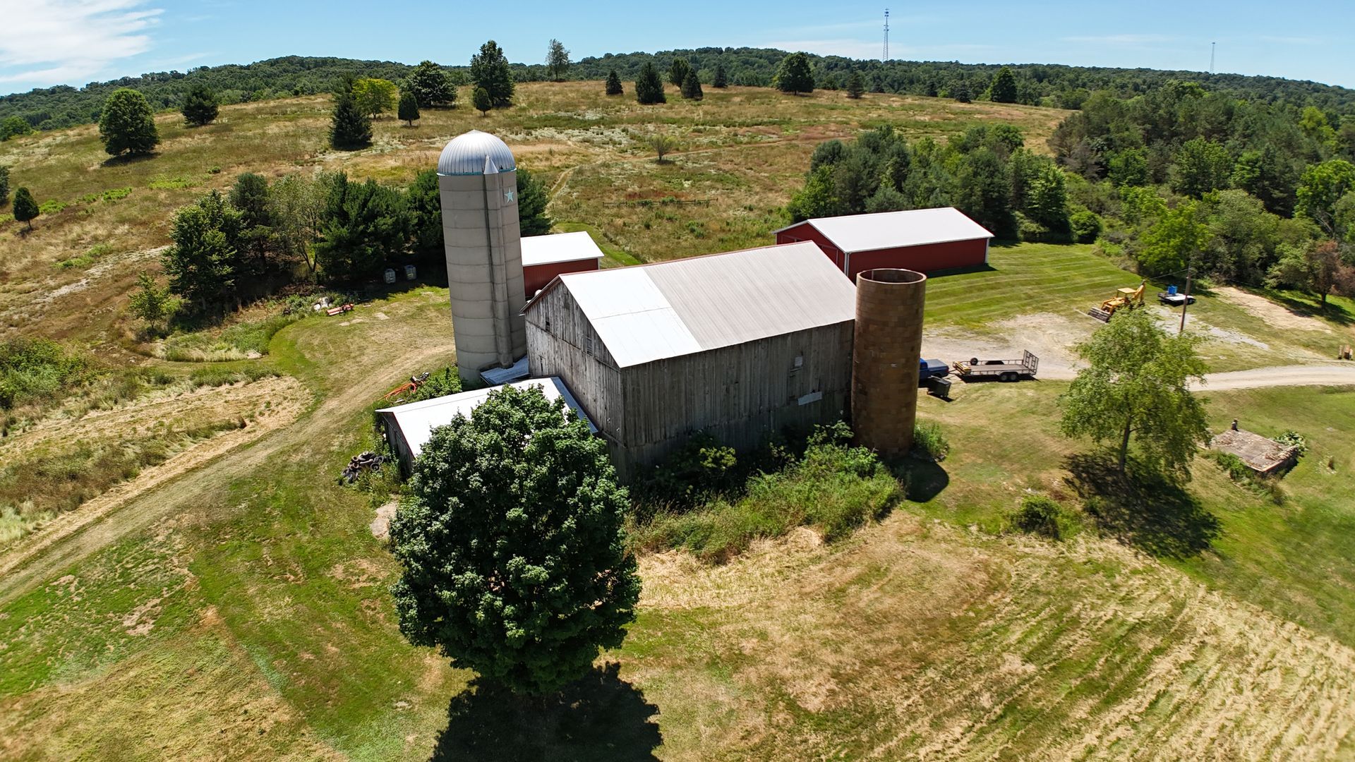 Bay & Bent USA aerial view of a rural farm with silo restoration needs