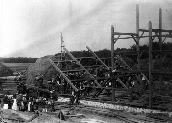 Bartle-Brothers,-Public-domain,-via-Wikimedia-Commons A black and white photo of a barn under construction.