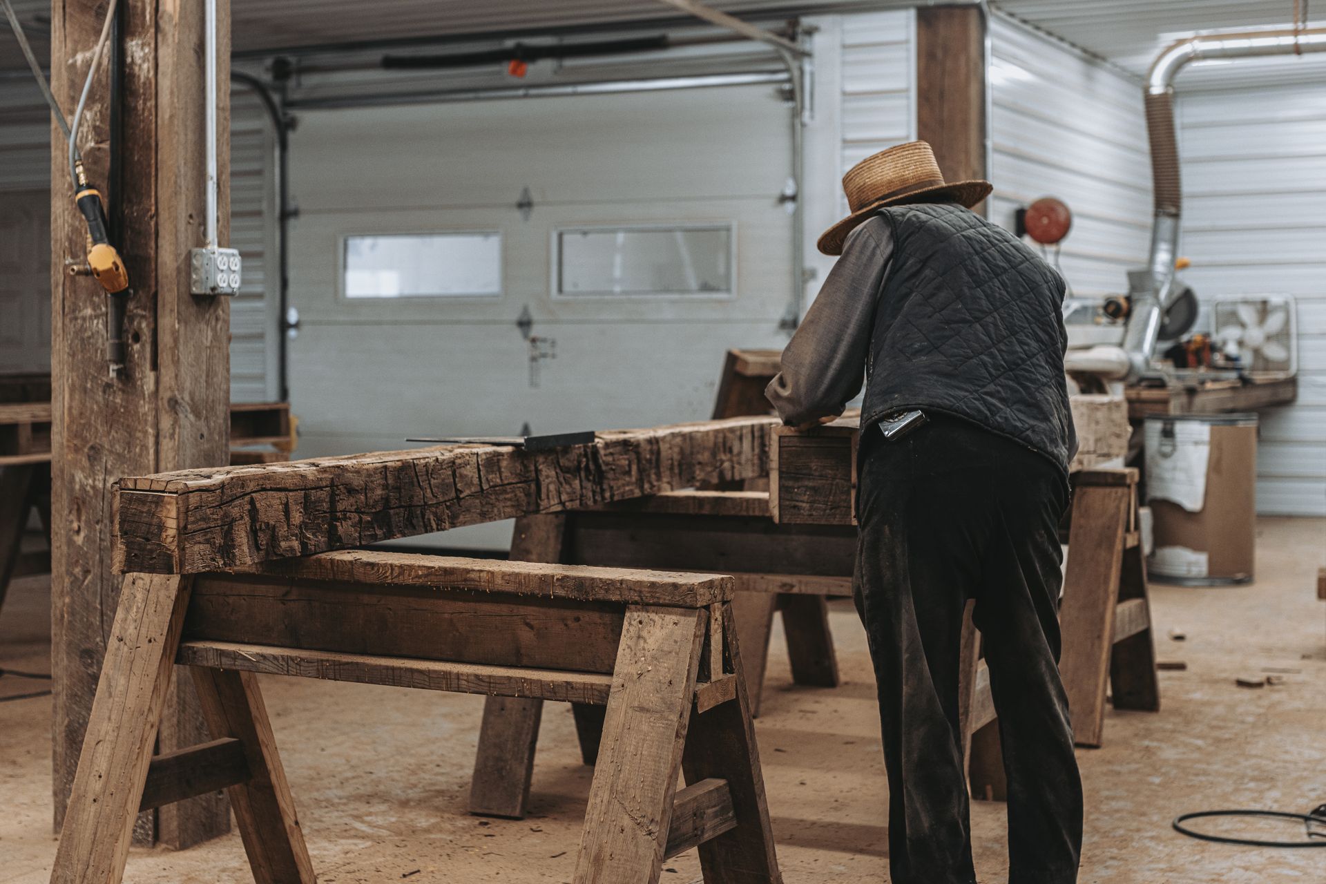 Amish craftsman working on a piece of antique reclaimed barn wood.