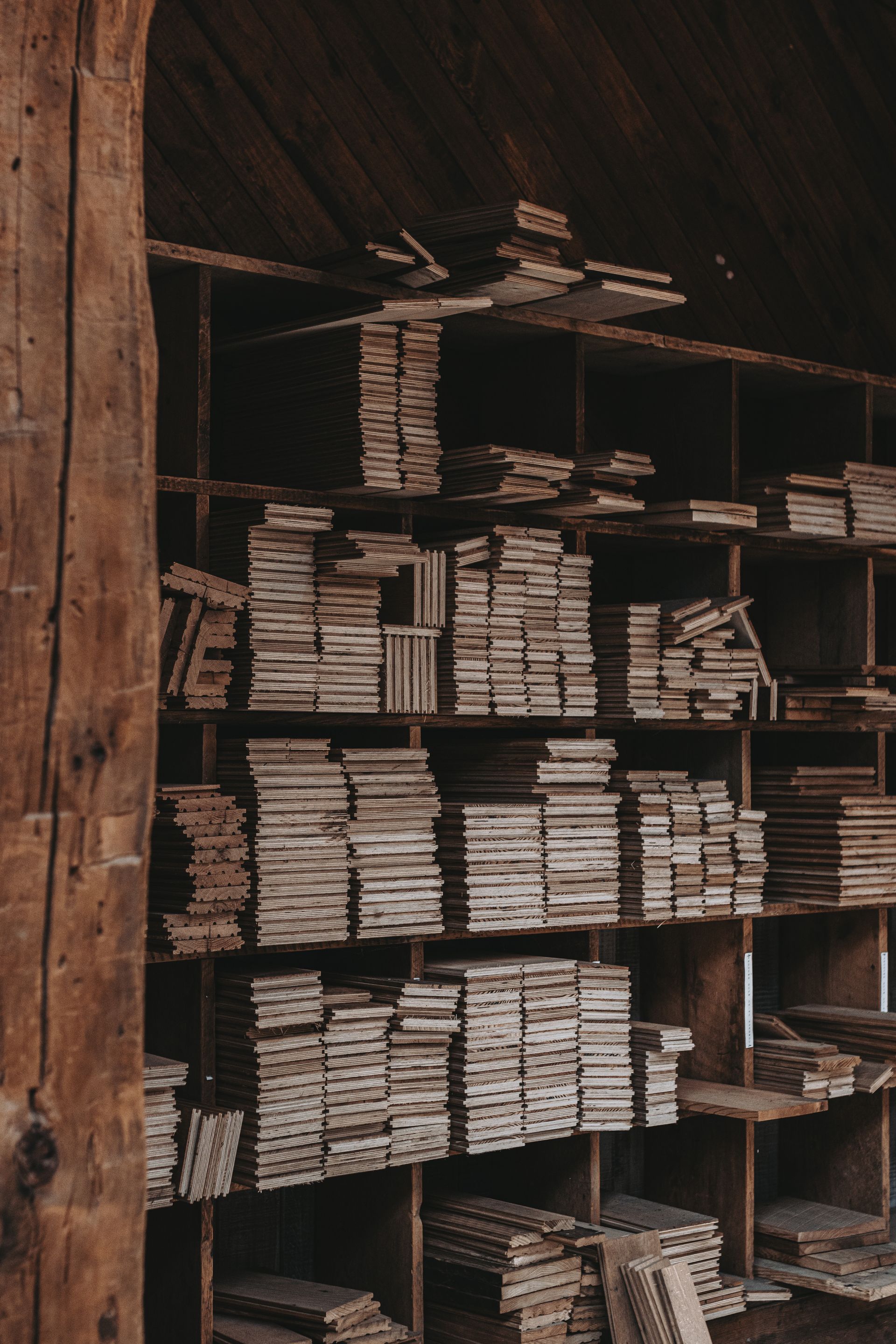 Planks of wood in a storage facility for heritage timber restoration projects.