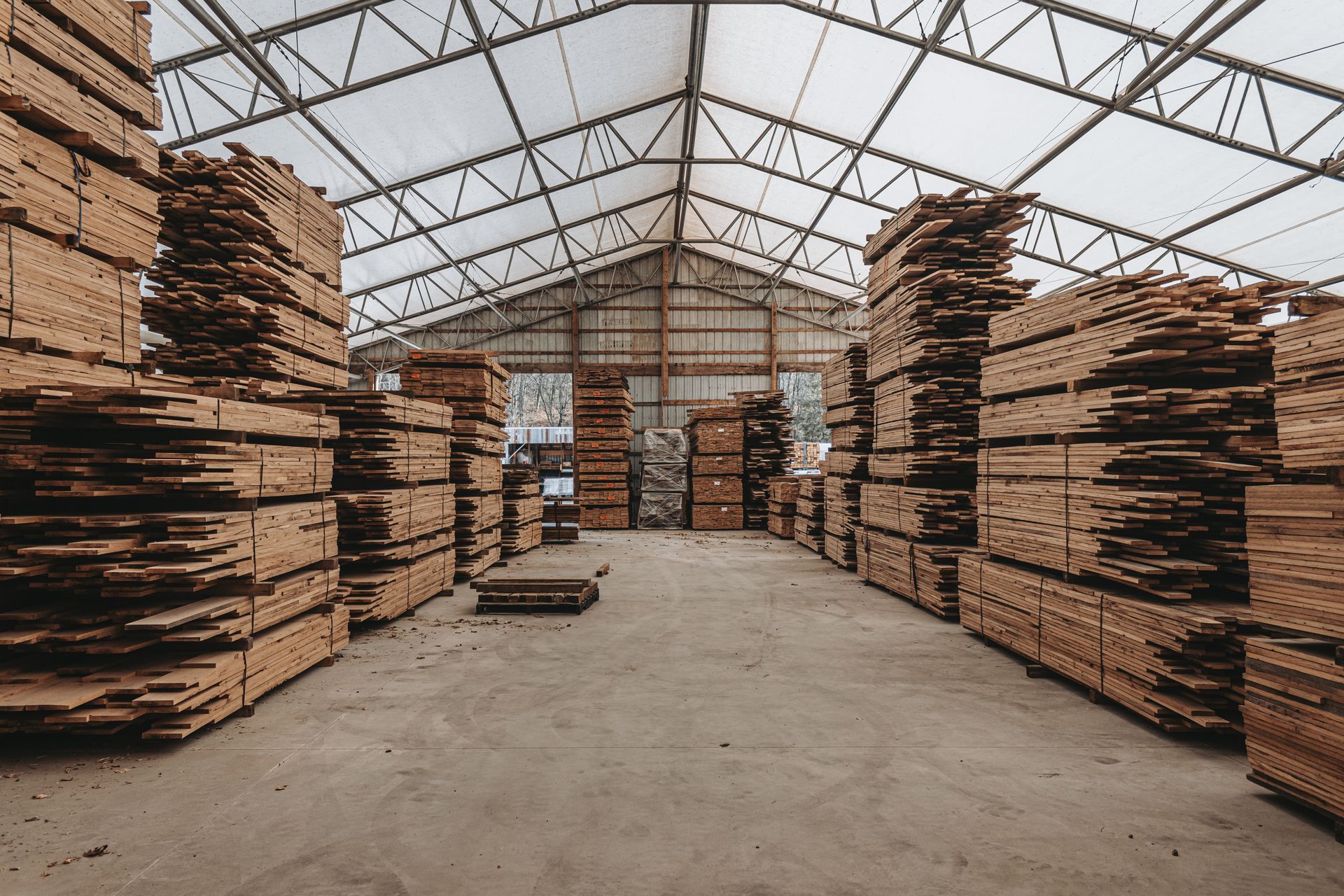 Warehouse with stacked wood for timber frame construction.
