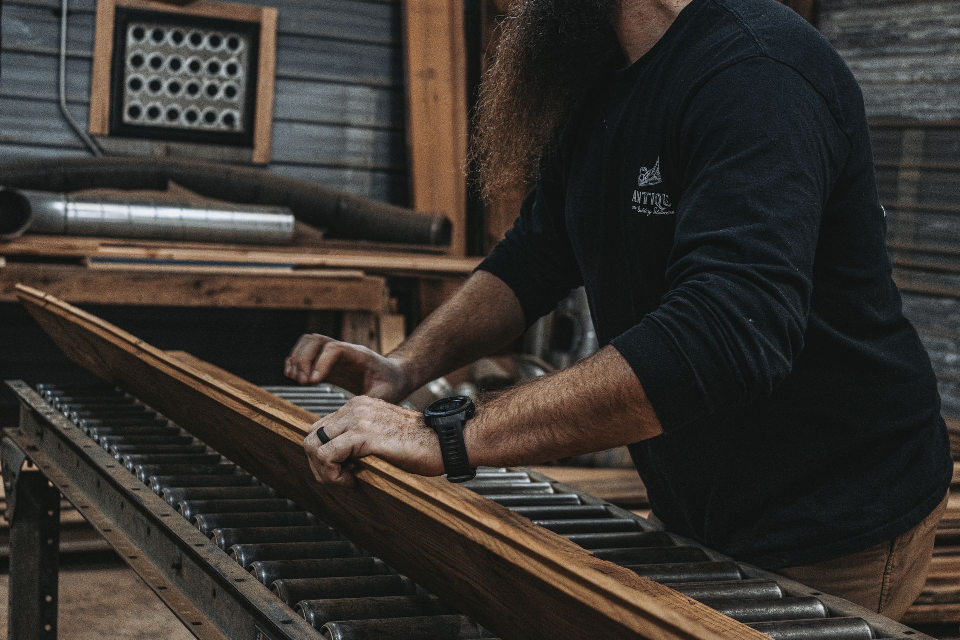 Craftsman inspecting a wooden plank, focusing on wood movement.