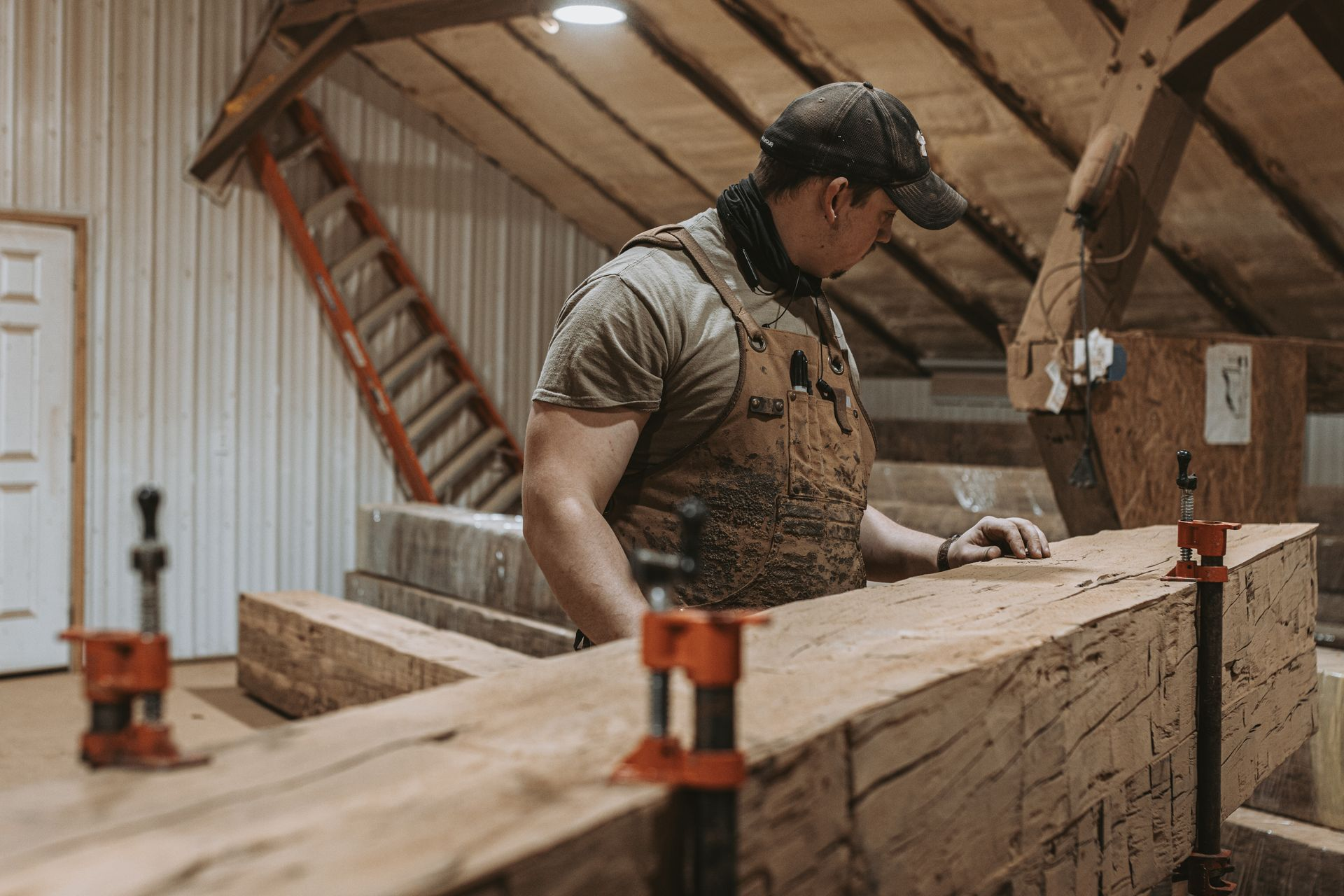 Craftsman securing a wooden beam with woodworking fasteners.