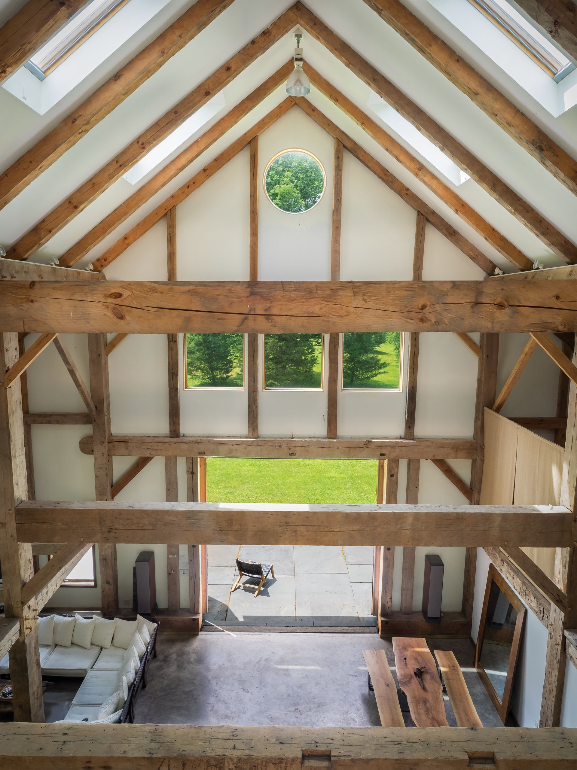 Spacious timber frame home interior with exposed beams.