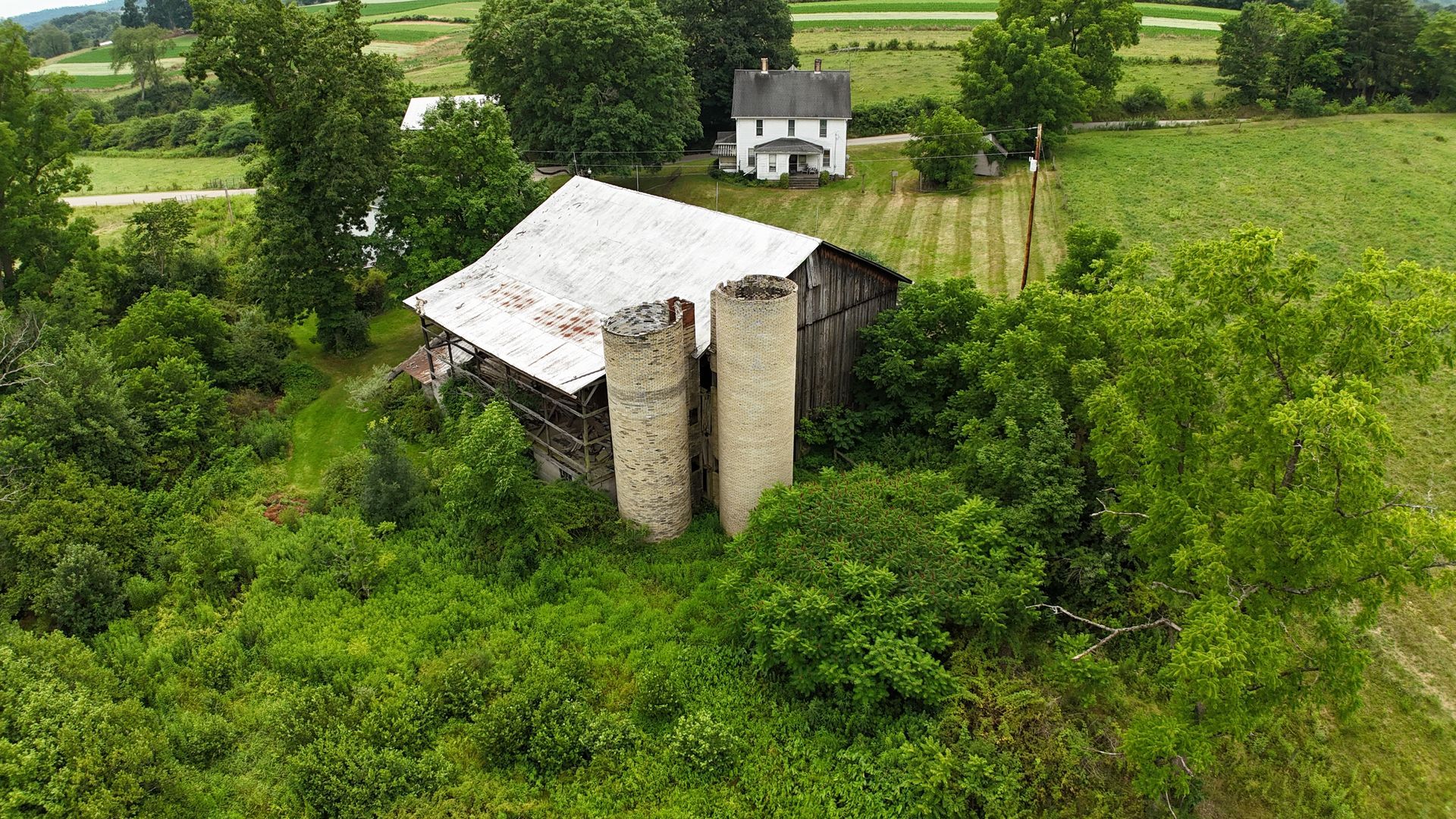 Aerial view of aging farm barn and silos awaiting silo restoration.