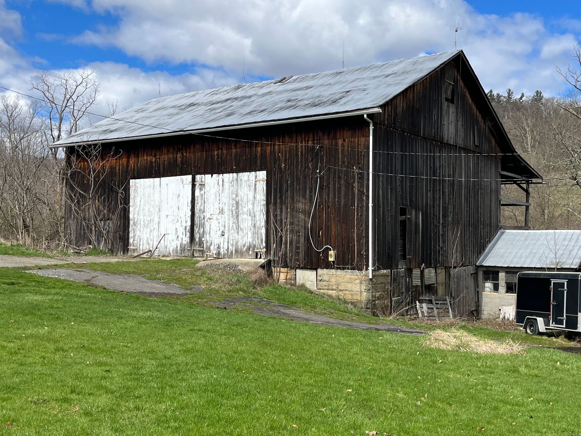 Rustic historic barn structure on a grassy field in the Pennsylvania countryside