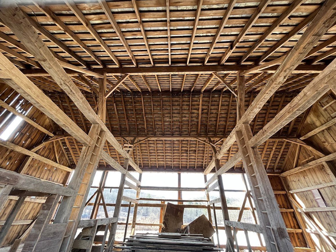 Interior of a rustic timber frame home under natural light.