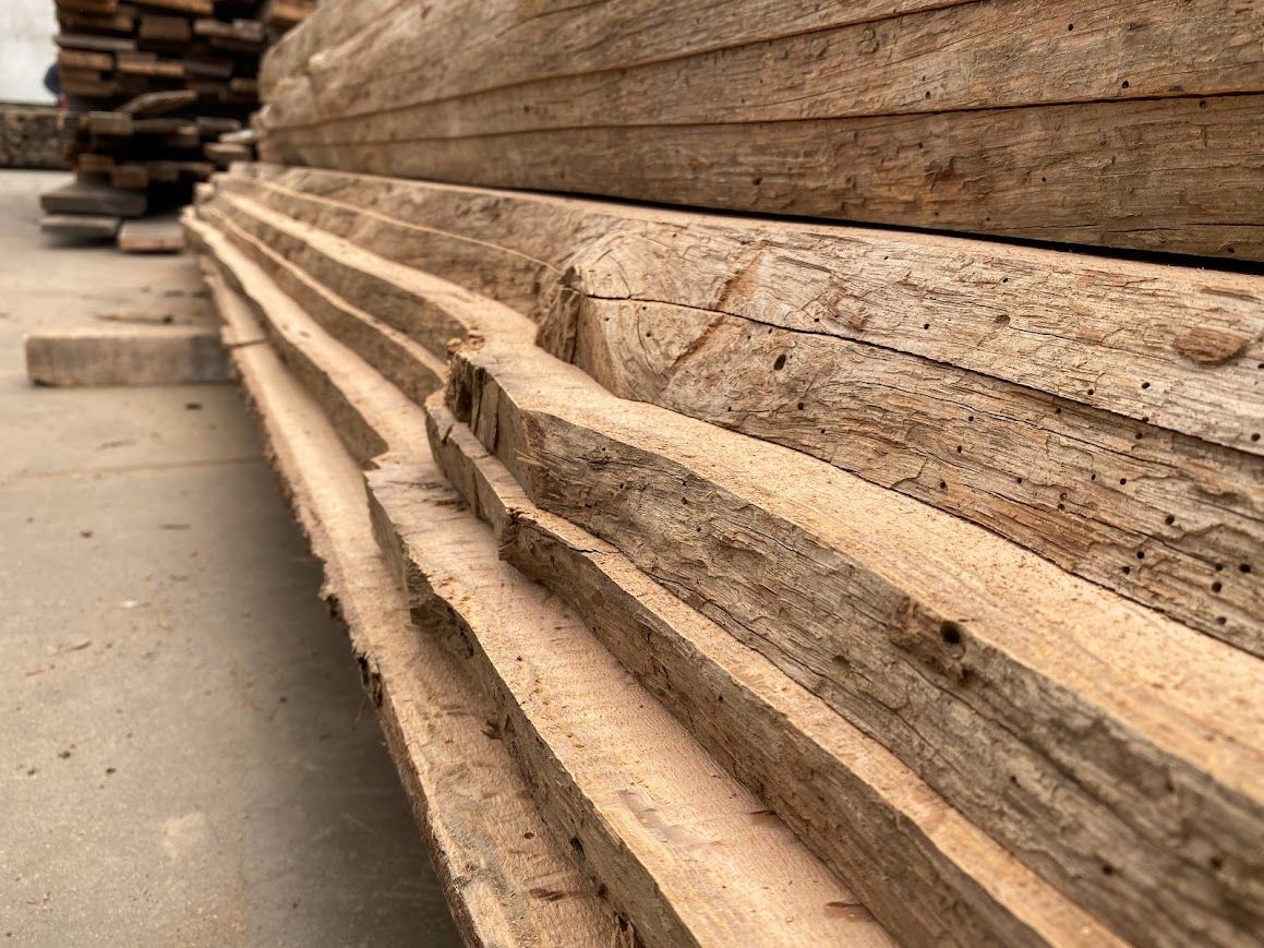 Stack of rough-cut quarter-sawn lumber beams.
