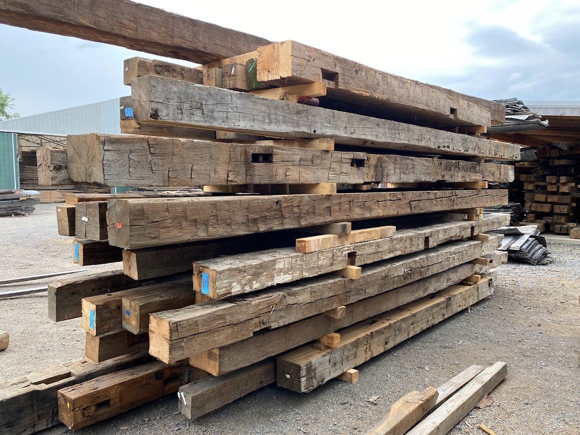 Stack of reclaimed wooden beams showcasing dado joints.