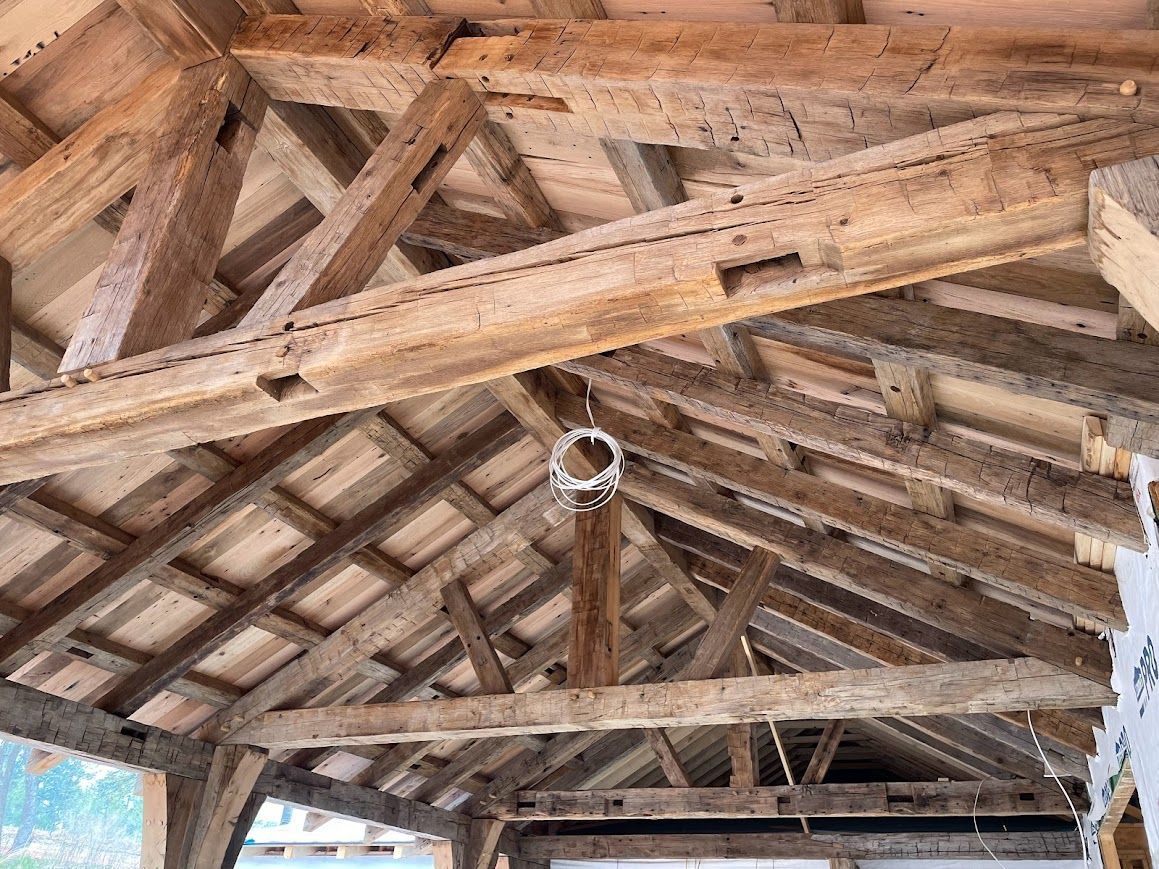 Interior wooden beams highlighting timber frame home cost.