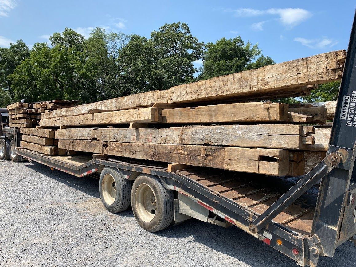 Flatbed truck loaded with eco-friendly lumber planks.
