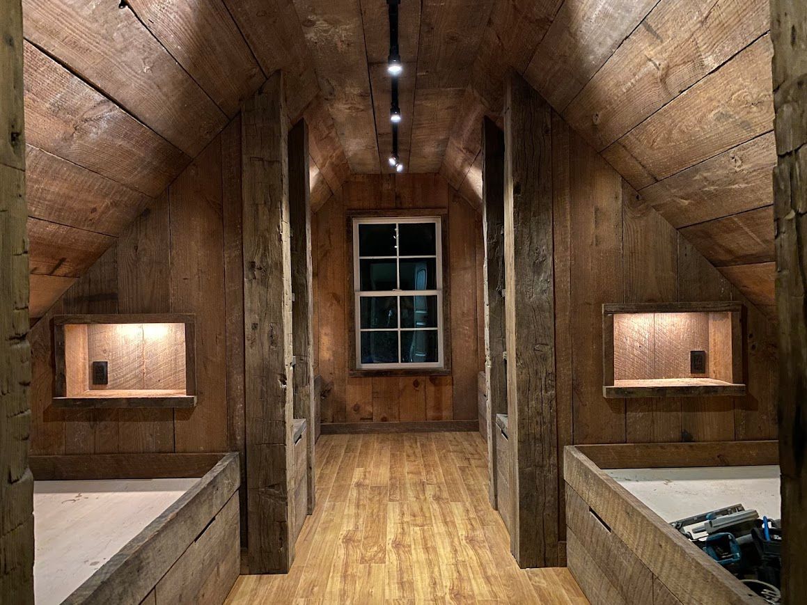 Rustic Attic Room with Barnwood Accent Wall and Built-In Alcove Beds in Pennsylvania