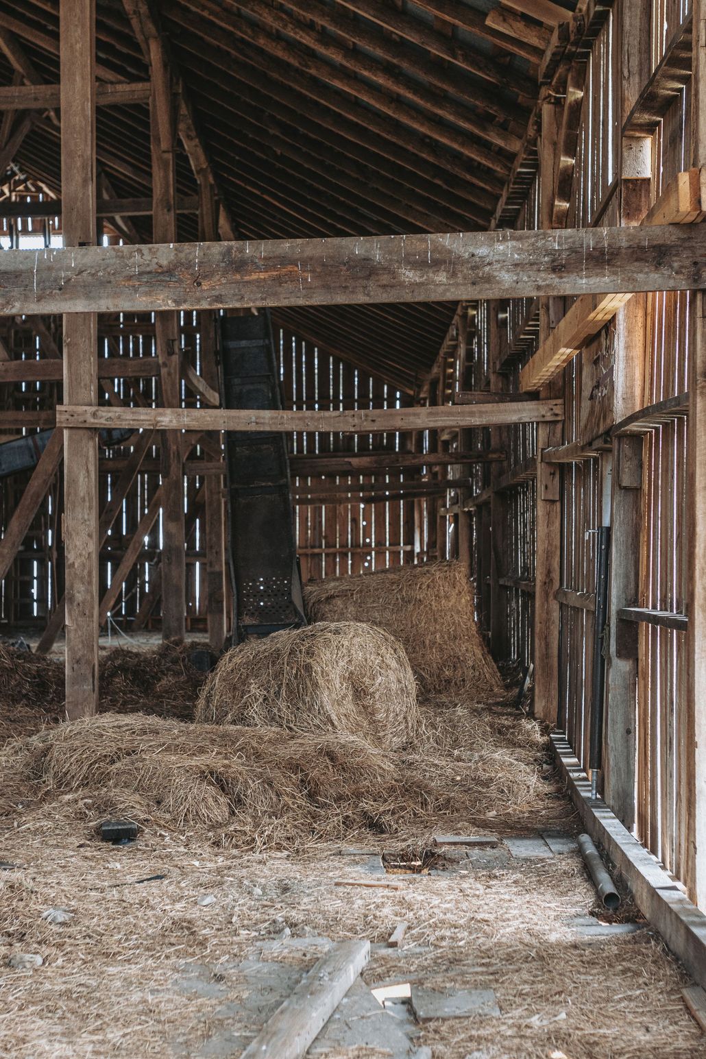 The inside of an old wooden barn with hay on the floor. Reclaimed Frames for Sale