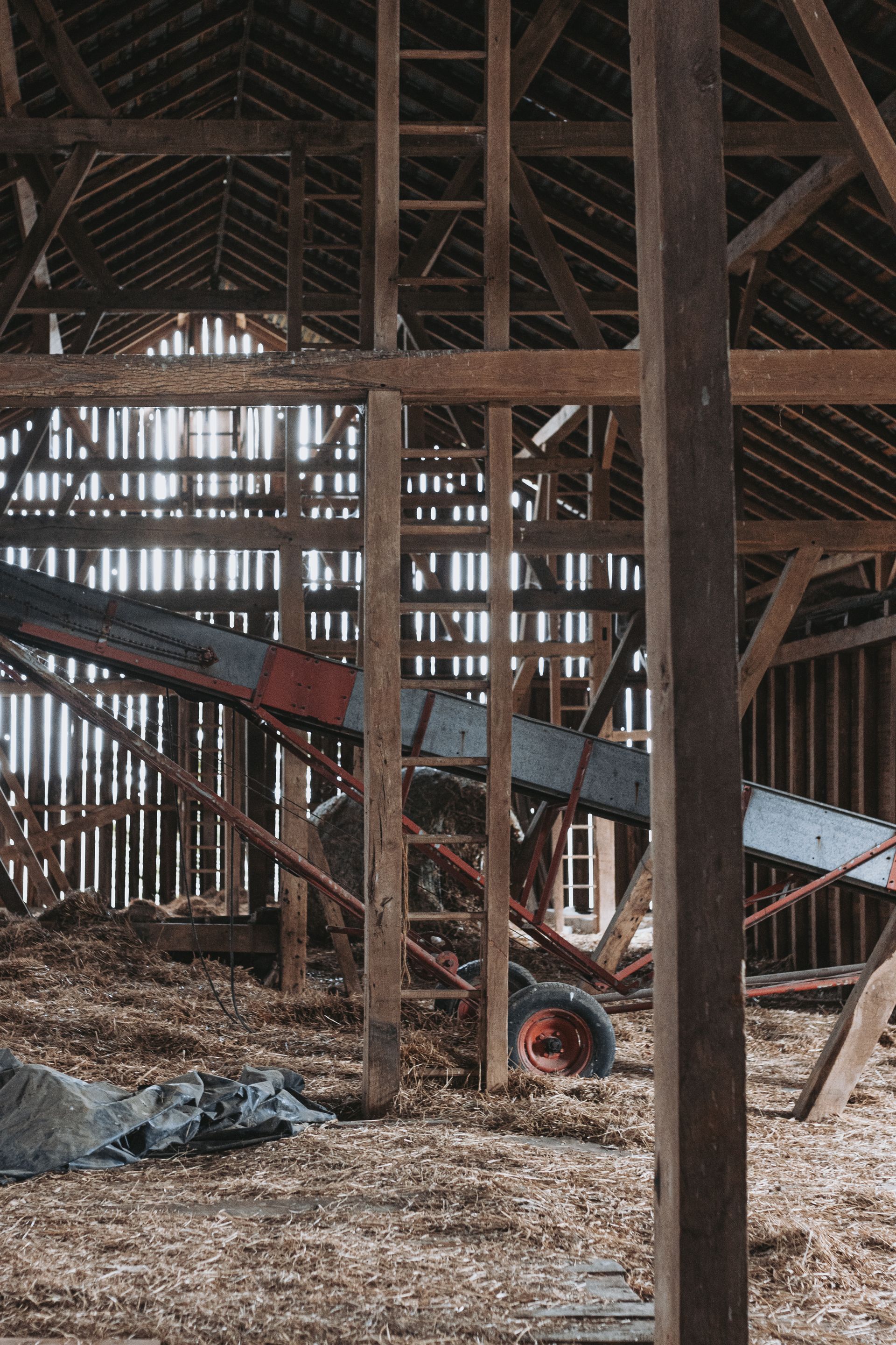 A historic wooden barn with a conveyor belt inside of it in Pennsylvania. 