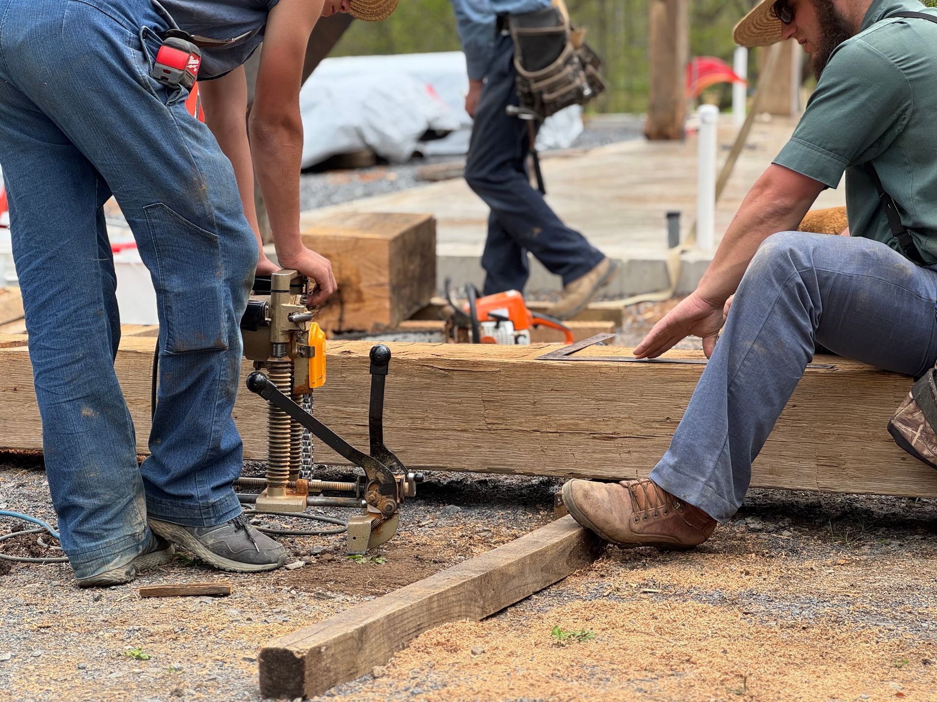 Crew drilling timber beams during construction of a metal building home in Pennsylvania.