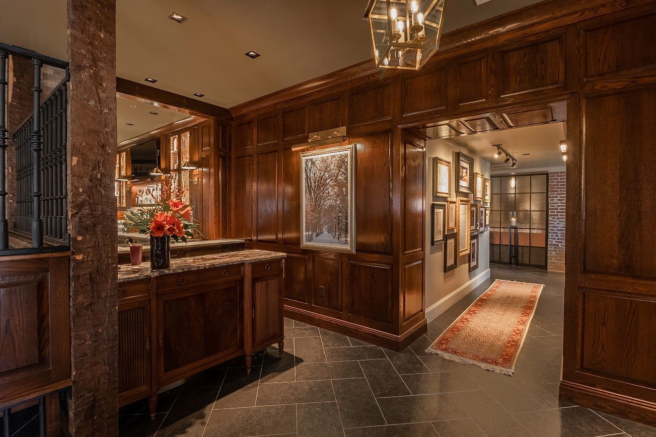 Elegant bar and hallway in historic event spaces with rich wood paneling.