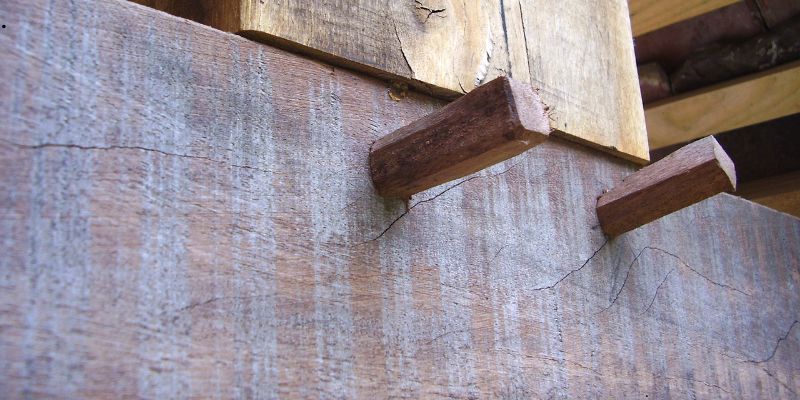 Close-up of wooden dowel joints in rustic wood.