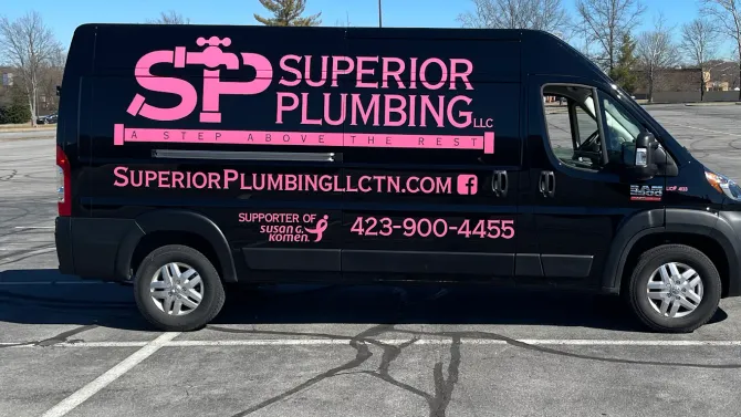 Black Superior Plumbing van with pink logo and website parked in a lot