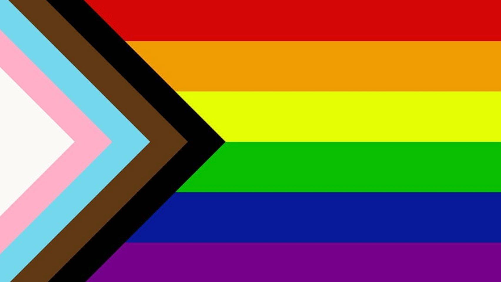 Un gros plan d'un drapeau arc-en-ciel avec une flèche pointant vers la droite.