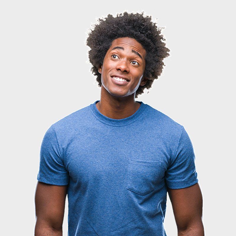 Smiling man in a blue T-shirt looking upward against a light gray background