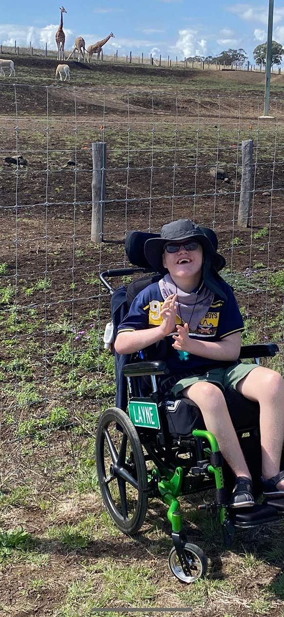 Young Girl In a Wheelchair Smiling While Enjoying Day on the Farm, Surrounded by Nature - Comfort N Care Support, QLD