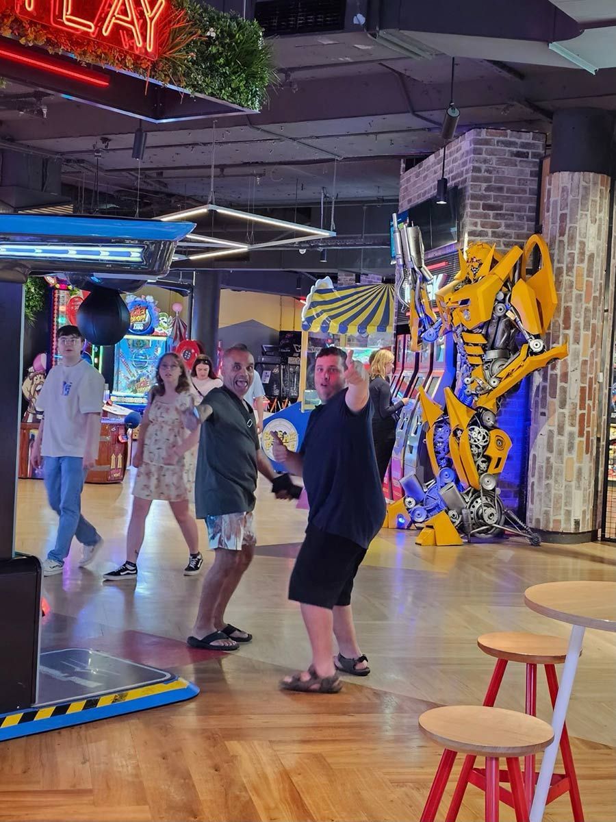 A Group of People Are Playing a Game in An Arcade — Comfort N Care Support QLD Pty Ltd In Toowoomba City, QLD