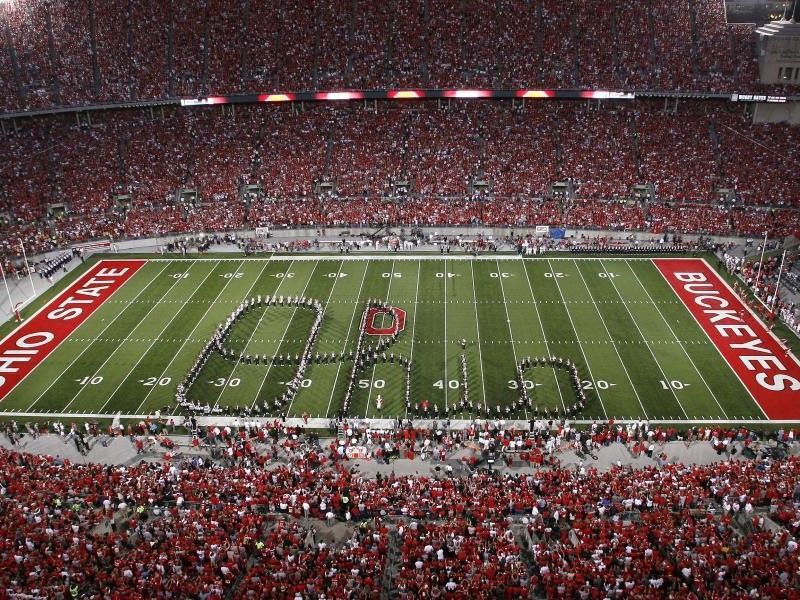 Football stadium packed with fans, field painted for a Buckeyes game, viewed from above