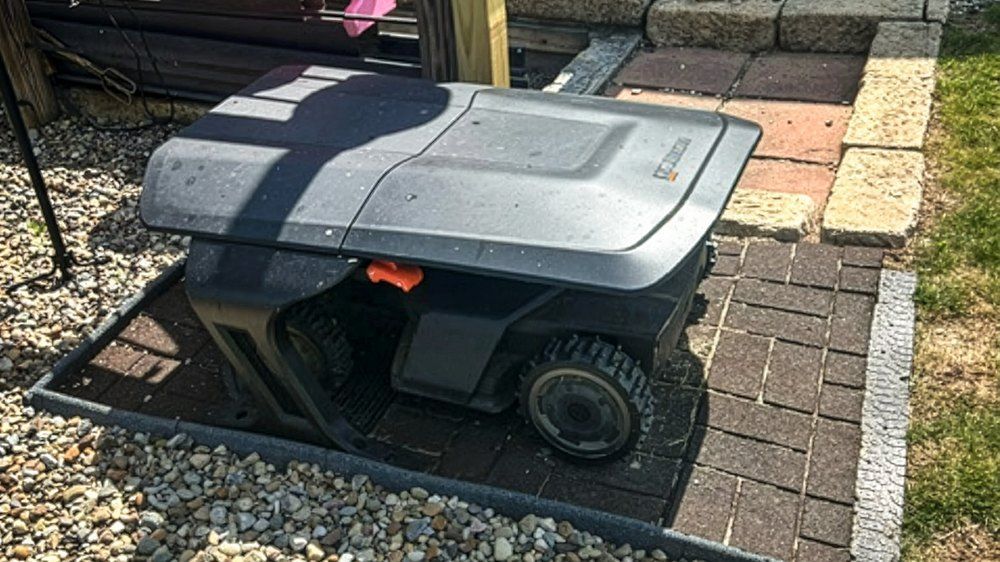 Side View of Navimow Robotic Mower in Outdoor Docking Hub