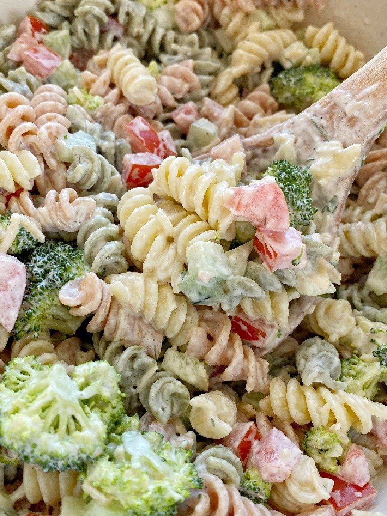 Creamy rotini pasta salad with broccoli and diced red peppers, tossed with a light dressing
