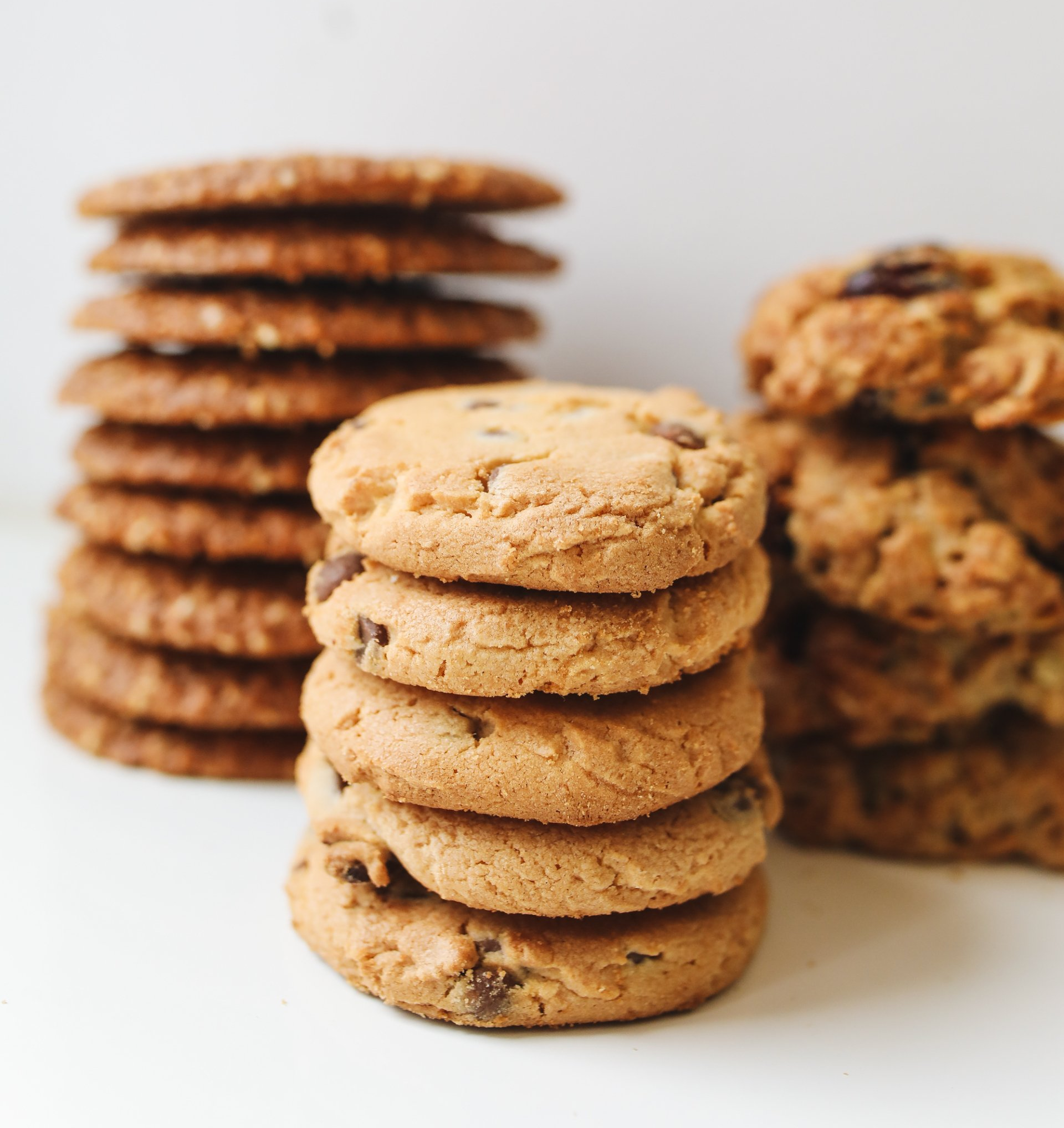 Stacks of chocolate chip cookies on a white background
