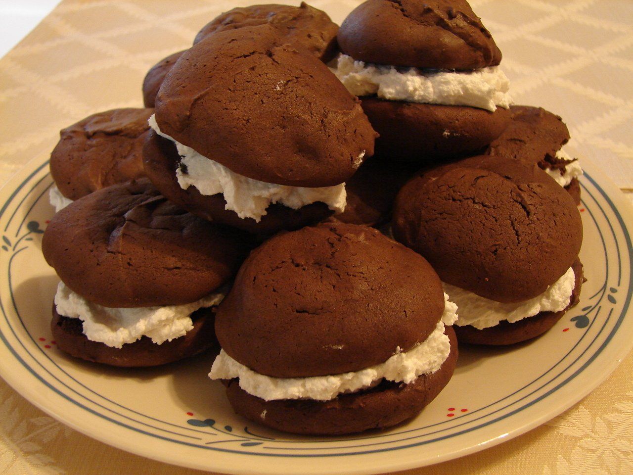 Plate of chocolate sandwich cookies filled with white cream