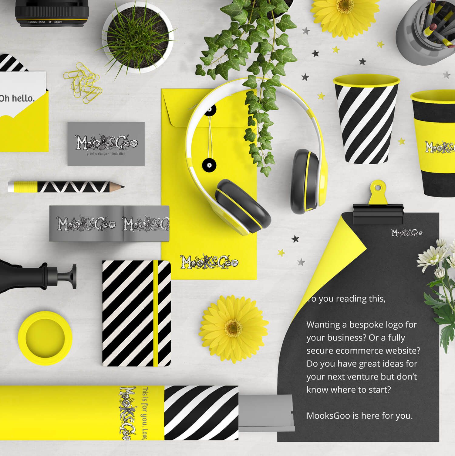 Flat lay of printed office supplies in black and yellow: headphones, notepad, pens, cups, and flowers. Designed by MooksGoo
