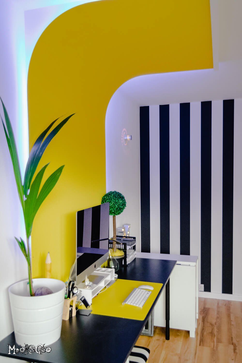 Unique home office inspiration with yellow walls and black and white striped wallpaper with a bright yellow curved wall. Interior design by MooksGoo